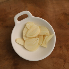 Garlic in a plate on white background