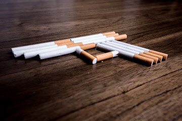 Burning cigarette with smoke and concept of cigarettes shaped as a gun to kill