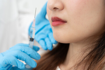 Naklejka premium Cosmetic surgery, skin whitening injection, filler injection, Skin reface, beautiful Asian girls receive beauty treatments at beauty clinic, skincare, pore rejuvenation, wrinkle, baby face.