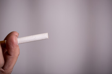 Burning cigarette with smoke and concept of cigarettes 