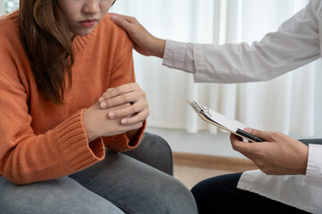 psychiatrist holds shoulders while discussing life and family issues. doctor encourages and empathy...