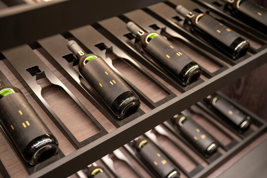 Wine bottles stored in a modern metal rack display