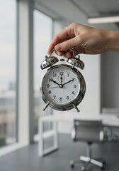 Photo Close-Up Of Person Holding A Silver Alarm Clock In Office Lighting