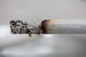 Burning cigarette with smoke and concept of cigarettes 