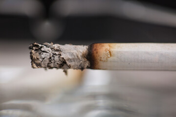 Burning cigarette with smoke and concept of cigarettes 