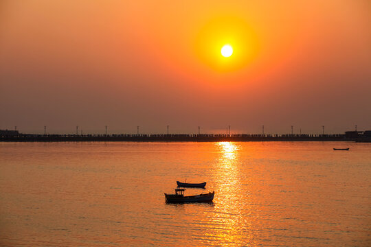 Boats silhouette sailing in sunset in Mumbai shore near Haji Ali Dargah