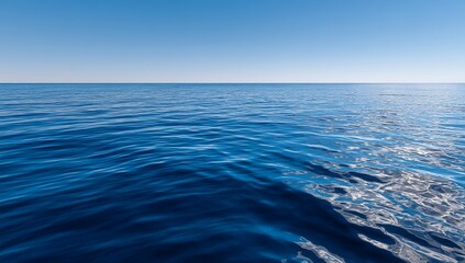 Obraz premium Calm ocean surface under a clear blue sky
