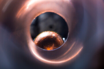 Macro view of weapon barrel with bullet at the end