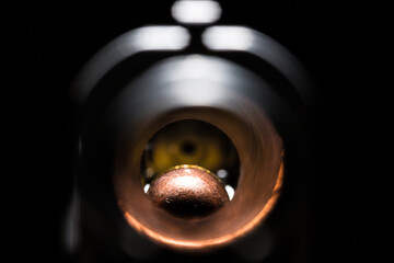 Macro view of weapon barrel with bullet at the end