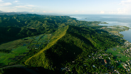 Aerial Sunrise Over Mountain Town in Tropical Forest