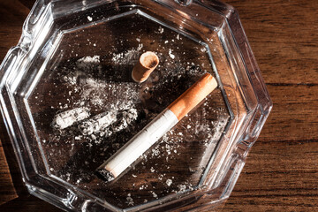 Burning cigarette with smoke and concept of cigarettes 