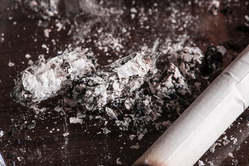 Burning cigarette with smoke and concept of cigarettes 