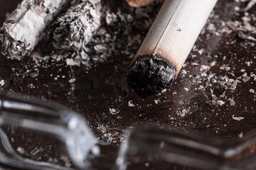 Burning cigarette with smoke and concept of cigarettes 