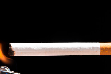 Burning cigarette with smoke and concept of cigarettes 