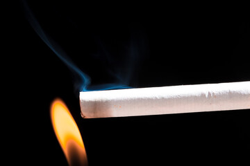 Burning cigarette with smoke and concept of cigarettes 
