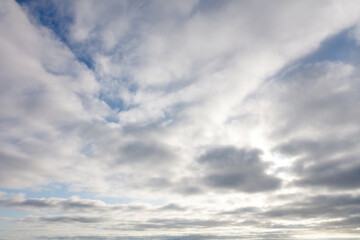 The sky is cloudy and the sun is shining through the clouds