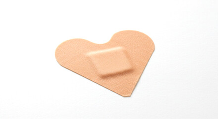 Heart-Shaped Bandage on White Background