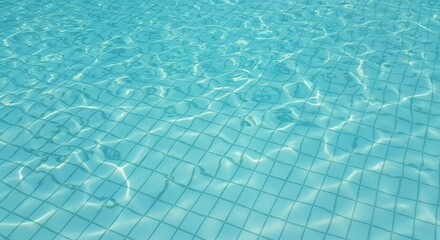 Pristine blue water of a swimming pool, highlighting the clean, tiled floor through its ripples.
