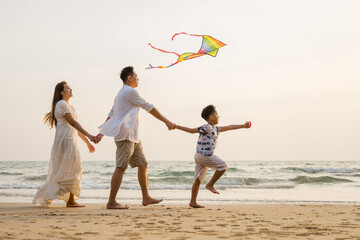 Asian family beach vacation. Children parent relax together. People lifestyle.