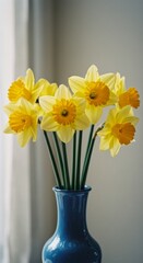 Photo of Daffodils in Blue Vase Against a Soft Background