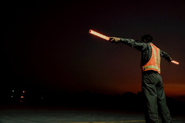 Ground traffic controller at night at airport termina © Isaranont