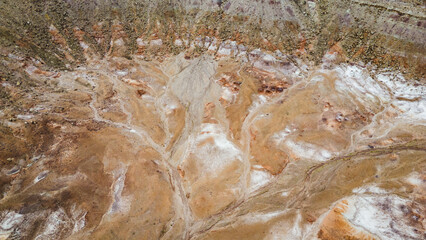 Aerial view of layered desert crater and eroded ridges in Utah