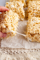 Fingers Pulling Gooey Rice Krispy Treat Square
