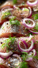 Vertical close-up of marinated herring with onions, dill, and black pepper