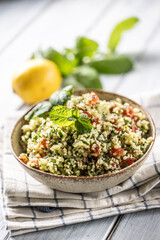 Traditional Tabouleh salad with bulgur, parsley, cucumber, tomato, coriander, garlic, mint and other ingredients