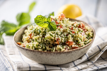 Traditional Tabouleh salad with bulgur, parsley, cucumber, tomato, coriander, garlic, mint and other ingredients