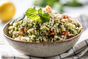 Traditional Tabouleh salad with bulgur, parsley, cucumber, tomato, coriander, garlic, mint and other ingredients