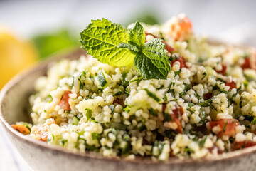 Traditional Tabouleh salad with bulgur, parsley, cucumber, tomato, coriander, garlic, mint and other ingredients
