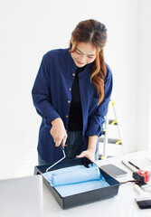 Asian young beautiful woman smiling cheerful happy long curly hair wearing blue shirt jeans...