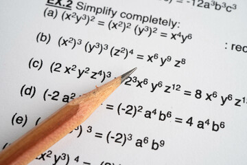 Pencil on mathematic formula exercise test paper in education school.