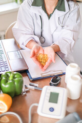Close-up of doctor holding handful of clear yellow oval capsules in palms. dietary supplements, vitamin d, omega 3, fish oil.