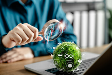 Businesswoman analyzing sustainable development and green energy investment using magnifying glass...