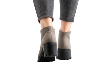 Steps Ahead: A close-up shot showcases stylish footwear and the lower legs of a person in motion, dressed in grey trousers, ready to take the next stride