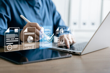 Fototapeta premium Businessman Using Digital Workflow System with Virtual Documents and Checklist Icons on Laptop and Tablet, Managing Online Reports, Analytics, and Task Completion in a Paperless Office Environment