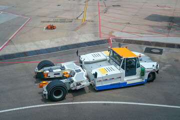 Tow truck vehicles trailer for push back plane at the airfield, near parking