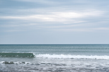 Waves at the Beach and cloudy sky