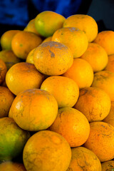 Food Series : Fresh oranges on a fruit stand. Tangerine background. Vegetarian food. Fresh oranges backdrop. Vegan food concept. Vegetarian food. Fruit texture.