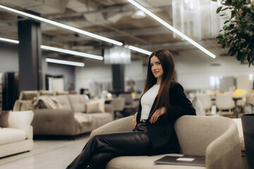 Young Woman Relaxing in a Modern Furniture Store Surrounded by Stylish Sofas