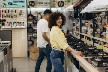 Young Woman Shopping for Kitchen Appliances in an Electronics Store