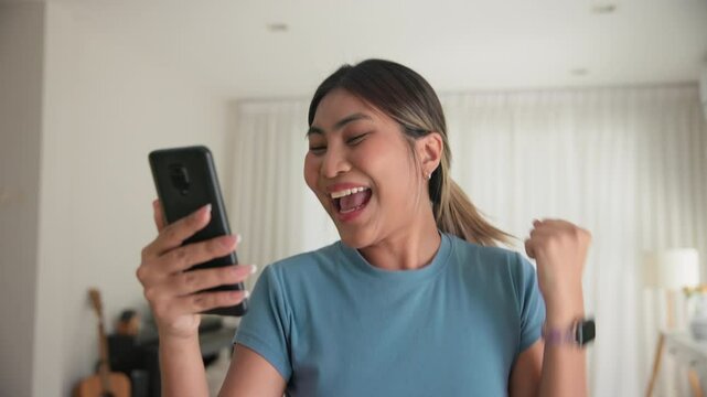 Asia young adult black people humor bizarre funny dance good news at home living room happy joy job hired interview result on mobile, award bonus, win luck bet online game order trade, loan money.