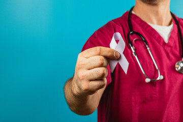 Healthcare professional advocates awareness with cancer ribbon in studio