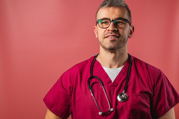 Confident male healthcare professional smiling while wearing scrubs