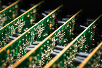 Green printed circuit boards and chips used in electronic devices, boards are in a row, close up.
