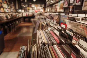 Fotobehang Muziekwinkel A close-up view of neatly organized vinyl records in a vintage-style music store. The records are categorized with labeled dividers, creating an inviting and nostalgic atmosphere.   © Peeradontax