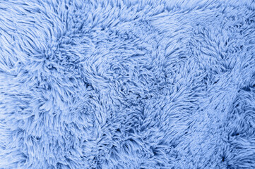 A close-up view of a soft, fluffy blue fabric, showcasing a textured background.