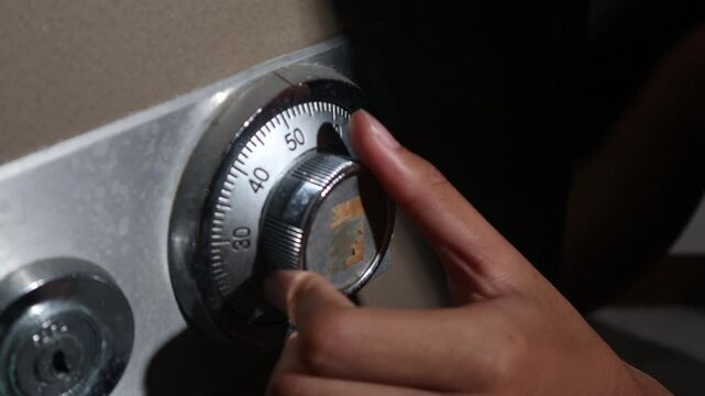 a thief is opening a safe